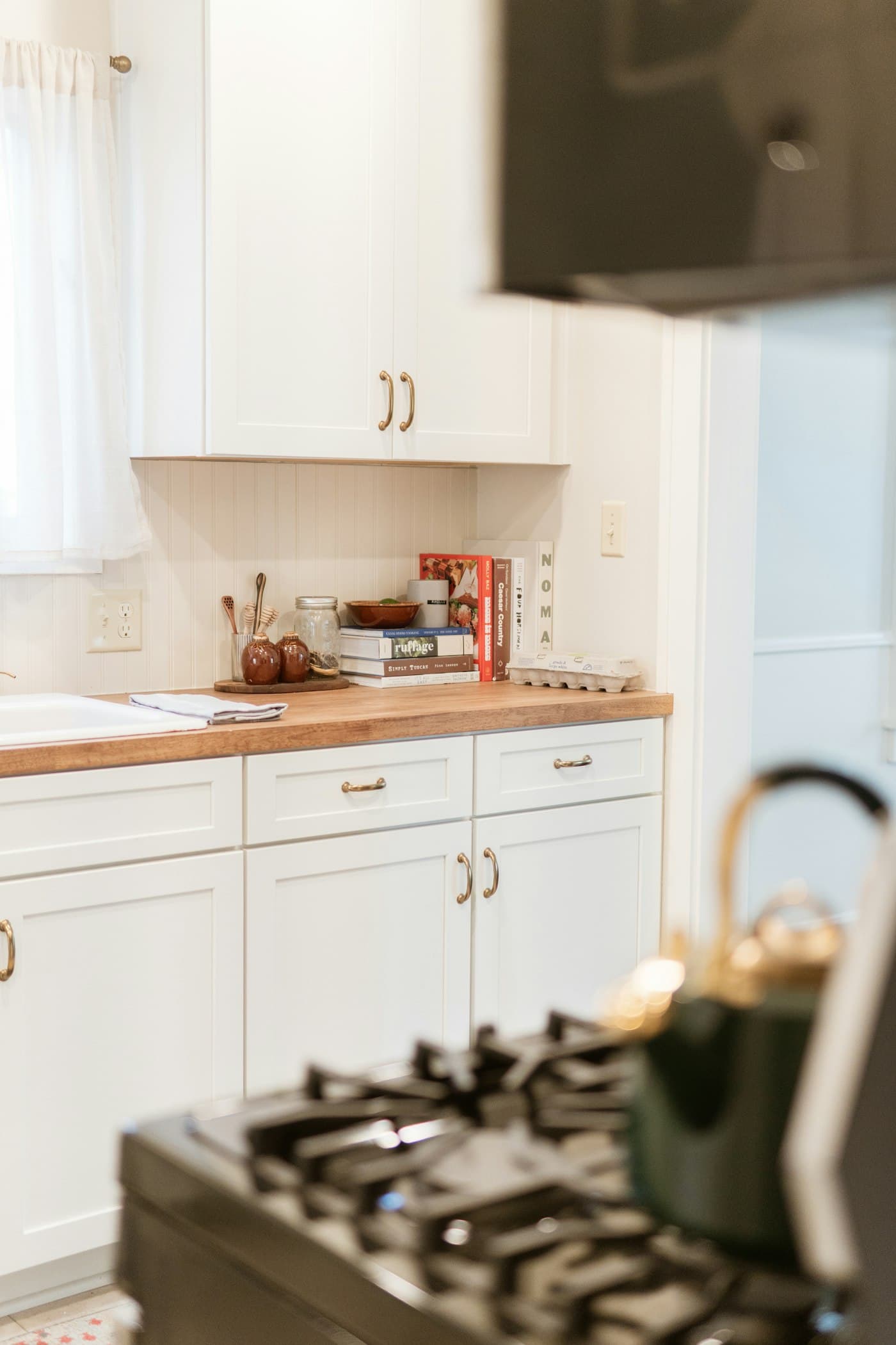 Detail of a finished white cabinet kitchen corner with brass hardware