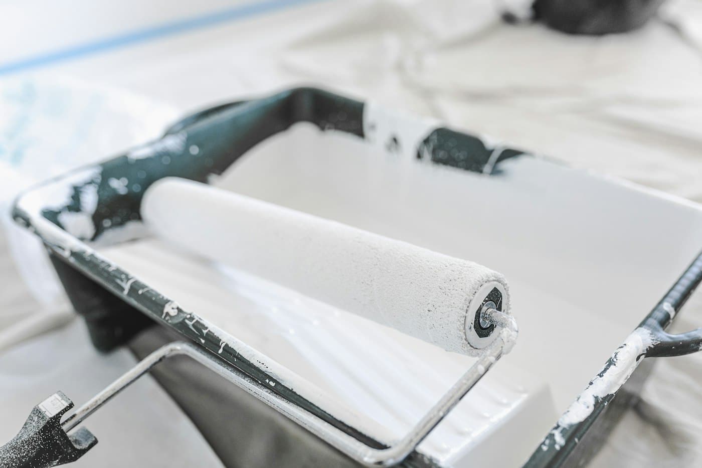 Close-up of a clean paint roller resting in a paint tray